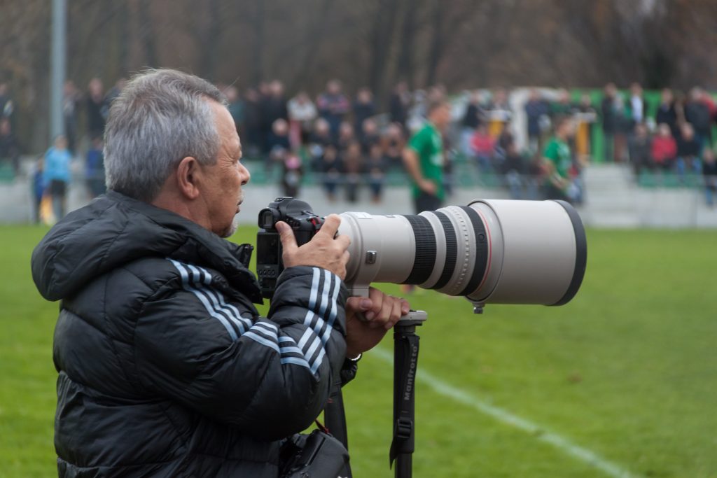 Sport photographer at a football match